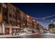 Nighttime street view showcasing modern architecture, outdoor dining, and streetlights, creating a lively ambiance at 5704 E Aire Libre Ave # 1246, Scottsdale, AZ 85254