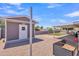 Backyard view with a storage shed, gravel, covered patio, grassy area, and garden bed at 6749 E Ellis St, Mesa, AZ 85205