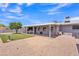 Beautiful backyard featuring gravel, covered patio, grassy area, and a well-maintained landscape at 6749 E Ellis St, Mesa, AZ 85205
