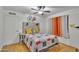 Cozy bedroom featuring a decorative quilt, modern ceiling fan, and soft, natural light at 6749 E Ellis St, Mesa, AZ 85205