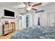 Comfortable bedroom featuring built-in closet, ceiling fan, and TV at 6749 E Ellis St, Mesa, AZ 85205