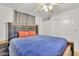 Bedroom showcases a plush blue bed, ceiling fan, and neutral decor for a tranquil retreat at 6749 E Ellis St, Mesa, AZ 85205