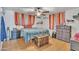 Cozy bedroom featuring wood floors, dresser, trunk, and modern ceiling fan at 6749 E Ellis St, Mesa, AZ 85205