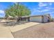 Charming single-story home featuring mature tree, covered patio, and a two-car garage at 6749 E Ellis St, Mesa, AZ 85205