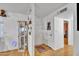 Bright hallway featuring wood floors and built-in shelving for storage and decor at 6749 E Ellis St, Mesa, AZ 85205