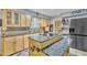 Kitchen with granite countertop island with cooktop, stainless steel appliances and lots of cabinet storage at 6749 E Ellis St, Mesa, AZ 85205