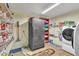 Laundry room with shelving and a refrigerator, washer, dryer, and tile floor at 6749 E Ellis St, Mesa, AZ 85205