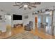 Bright living room with wood flooring, a ceiling fan, and an open layout to dining at 6749 E Ellis St, Mesa, AZ 85205