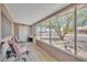 Cozy sunroom with comfortable seating and serene views of the landscaped front yard at 6749 E Ellis St, Mesa, AZ 85205