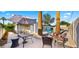 Backyard patio features a dining set with umbrella and view of pool at 6907 E Portland St, Scottsdale, AZ 85257