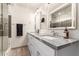 This bathroom includes double sinks, white cabinets, granite counters and a glass enclosed shower at 6907 E Portland St, Scottsdale, AZ 85257