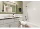 This bathroom features neutral walls, subway tiles in the shower, granite counters and white cabinets at 6907 E Portland St, Scottsdale, AZ 85257