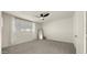 Bright bedroom with a ceiling fan, neutral carpeting, and view of the outdoors at 6907 E Portland St, Scottsdale, AZ 85257