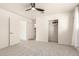 This bedroom features neutral walls, carpeted floors, a ceiling fan, and a closet with sliding doors at 6907 E Portland St, Scottsdale, AZ 85257