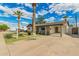 Spacious home with a large driveway and beautiful palm trees in a well-manicured lawn at 6907 E Portland St, Scottsdale, AZ 85257