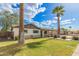 Attractive single-Gathering home featuring a lush lawn and mature desert landscaping at 6907 E Portland St, Scottsdale, AZ 85257