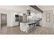 Modern kitchen features white cabinets, stainless steel appliances, and a large island with bar seating at 6907 E Portland St, Scottsdale, AZ 85257