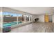 View of the living room through large windows highlighting the backyard pool at 6907 E Portland St, Scottsdale, AZ 85257