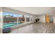 Open living room with a pool view, modern fireplace, and sliding barn door accent at 6907 E Portland St, Scottsdale, AZ 85257