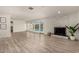 Bright living area with backyard pool views, fireplace, and stylish wood flooring at 6907 E Portland St, Scottsdale, AZ 85257