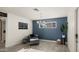 Charming living room with accent wall, modern lighting, and a decorative chair with ottoman at 6907 E Portland St, Scottsdale, AZ 85257