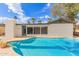 The backyard includes a bright blue pool and a home with white exteriors and a grey roof at 6907 E Portland St, Scottsdale, AZ 85257