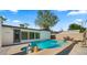Backyard features a private pool with nearby covered patio, surrounded by greenery at 6907 E Portland St, Scottsdale, AZ 85257