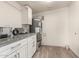 The utility room features neutral walls, wood look floors, white cabinets, and a grey water heater at 6907 E Portland St, Scottsdale, AZ 85257