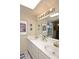 Bathroom features double sinks, a large mirror, and decorative prints at 6945 E Cochise E Rd # 117, Paradise Valley, AZ 85253