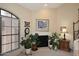 Bedroom featuring a window, potted plants, and a cozy fireplace at 6945 E Cochise E Rd # 117, Paradise Valley, AZ 85253