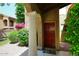 Inviting entryway with a solid wood front door and decorative column at 6945 E Cochise E Rd # 117, Paradise Valley, AZ 85253
