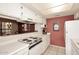 Efficient kitchen featuring white cabinets, appliances, and a pass-through window at 6945 E Cochise E Rd # 117, Paradise Valley, AZ 85253