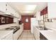 Galley kitchen with white cabinets, appliances, and tile flooring at 6945 E Cochise E Rd # 117, Paradise Valley, AZ 85253