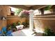 Private courtyard with a column, mature bougainvillea tree, and other landscaping at 6945 E Cochise E Rd # 117, Paradise Valley, AZ 85253