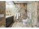 Modern bathroom featuring stone tile, glass shower, and sleek vanity at 7131 E Rancho Vista Dr # 7011, Scottsdale, AZ 85251