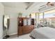 Cozy bedroom with a comfy bed, large windows, and stylish wooden dresser at 7131 E Rancho Vista Dr # 7011, Scottsdale, AZ 85251