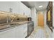 Convenient laundry room with modern appliances, granite countertops, and ample storage in a well-lit space at 7131 E Rancho Vista Dr # 7011, Scottsdale, AZ 85251