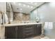 Stylish main bathroom with dual sinks, modern vanity, and travertine stone shower with glass door at 7131 E Rancho Vista Dr # 7011, Scottsdale, AZ 85251