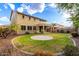 Expansive backyard features a lush lawn, mature trees and a circular brick feature at 7220 W Ashby Dr, Peoria, AZ 85383