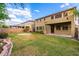 Expansive backyard features a lush lawn, patio, and mature trees perfect for outdoor entertaining and relaxation at 7220 W Ashby Dr, Peoria, AZ 85383