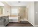Bright bathroom with a tub, sliding glass shower, and modern finishes at 7220 W Ashby Dr, Peoria, AZ 85383
