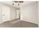 This bedroom features neutral walls, carpet, ceiling fan and two doors with black hardware at 7220 W Ashby Dr, Peoria, AZ 85383