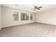 Carpeted bedroom featuring a modern ceiling fan and large windows at 7220 W Ashby Dr, Peoria, AZ 85383