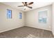 This bedroom features neutral walls, ceiling fan and carpet, and multiple windows with blinds at 7220 W Ashby Dr, Peoria, AZ 85383