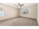 Bright bedroom featuring neutral carpet, a ceiling fan, and windows providing natural light at 7220 W Ashby Dr, Peoria, AZ 85383