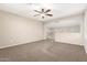 Upstairs bonus room featuring neutral carpeting and archway, bathed in natural light at 7220 W Ashby Dr, Peoria, AZ 85383