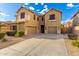Inviting two-story home featuring a spacious three-car garage and a well-maintained gravel front yard at 7220 W Ashby Dr, Peoria, AZ 85383