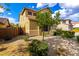 Inviting two-story home featuring desert landscaping, manicured bushes, a shade tree, and a brick fence at 7220 W Ashby Dr, Peoria, AZ 85383
