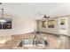 Kitchen island with sink and granite countertops, opening to the naturally lit living room at 7220 W Ashby Dr, Peoria, AZ 85383