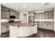 Gourmet kitchen featuring a large island with granite countertops and stainless steel appliances at 7220 W Ashby Dr, Peoria, AZ 85383